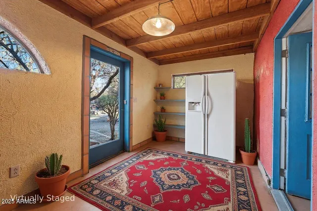 a living room with furniture a fireplace and a large window