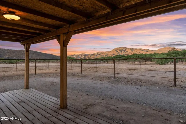 an aerial view of house with yard and mountain view in back