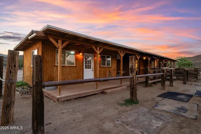 a kitchen with stainless steel appliances granite countertop a refrigerator a sink dishwasher a stove with white cabinets and wooden floor