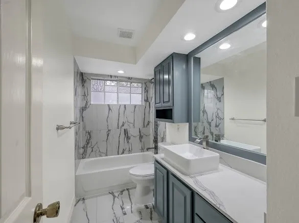 a kitchen with granite countertop stainless steel appliances and wooden cabinets