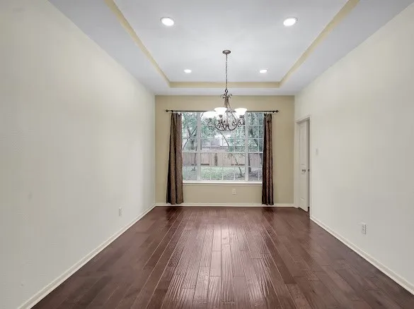 a view of livingroom with chandelier and wooden floor
