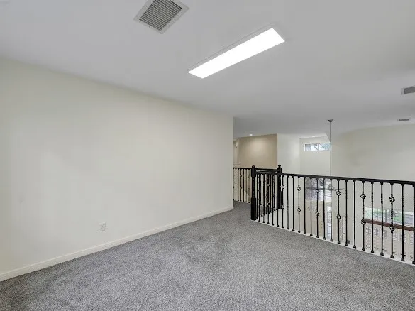 a spacious bathroom with a granite countertop sink and a large mirror