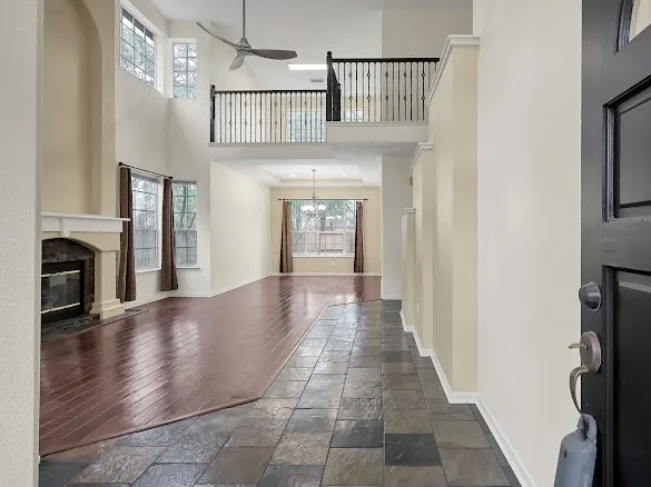 a view of entryway and hall with wooden floor