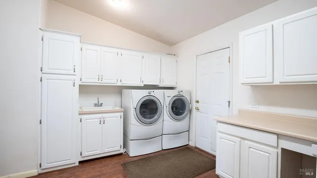 a bedroom with a large bed and a flat tv screen on a dresser