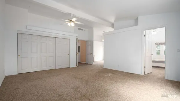 a bedroom with a bed and a painting on the wall