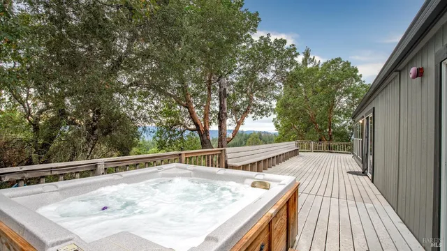a view of balcony with wooden floor and fence