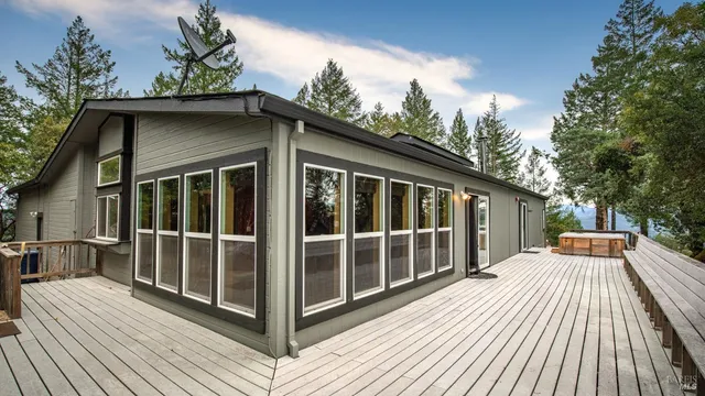 a view of backyard with deck and wooden floor