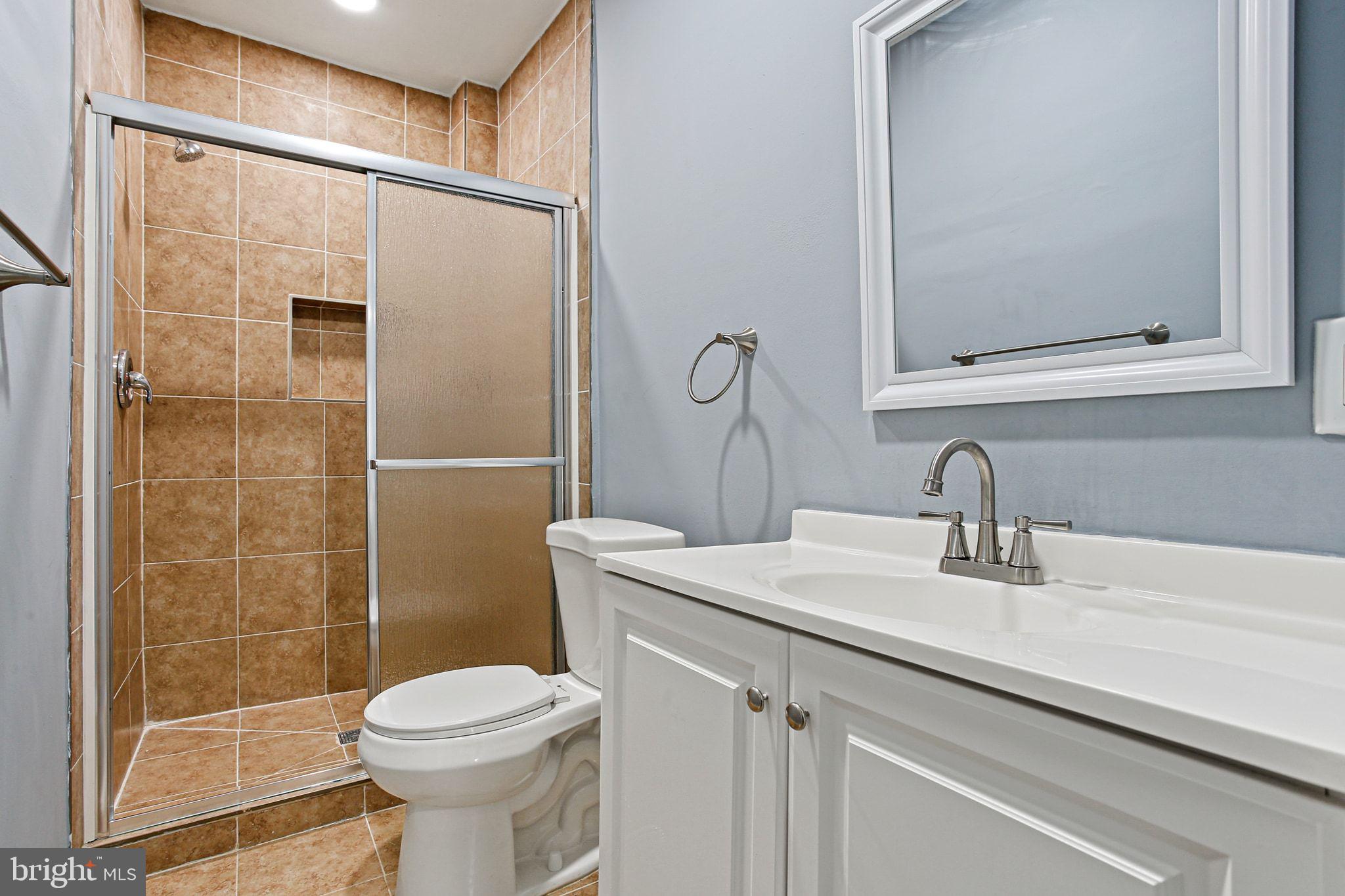 2811 Erdman Avenue Baltimore, MD 21213 - Photo 13 of 17 a bathroom with a sink a toilet and shower