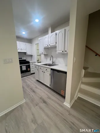 a large kitchen with cabinets and wooden floor