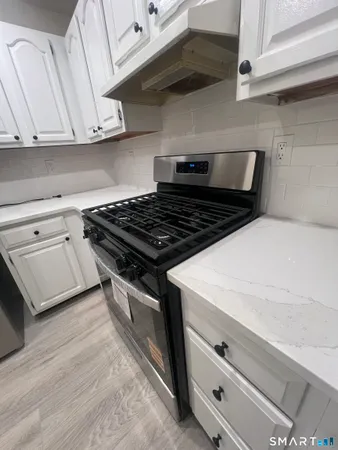a stove top oven sitting inside of a kitchen