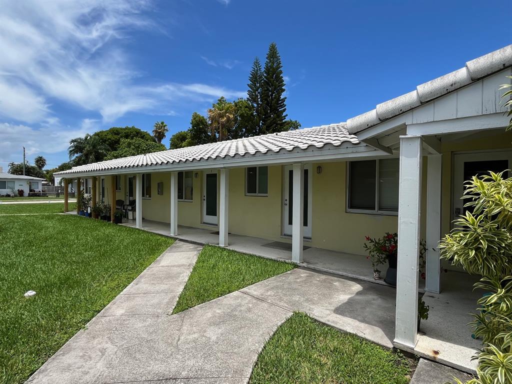 1712 Fletcher Street, Unit 5 Hollywood, FL 33020 - Photo 2 of 11 a front view of a house with a garden and plants