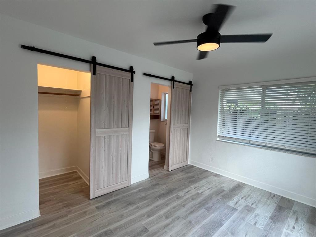 1712 Fletcher Street, Unit 5 Hollywood, FL 33020 - Photo 5 of 11 a view of an empty room with wooden floor and a window