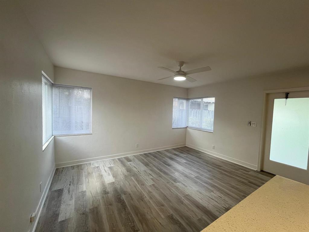 1712 Fletcher Street, Unit 5 Hollywood, FL 33020 - Photo 7 of 11 an empty room with wooden floor and windows