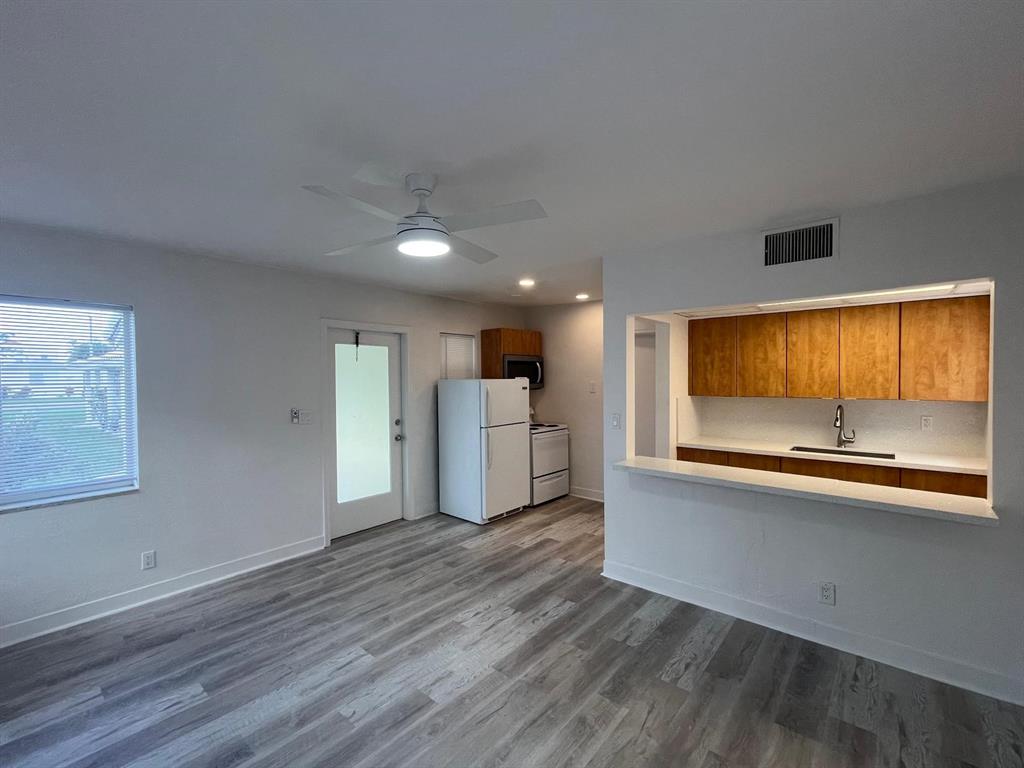 1712 Fletcher Street, Unit 5 Hollywood, FL 33020 - Photo 9 of 11 a view of a kitchen with wooden floor and a window