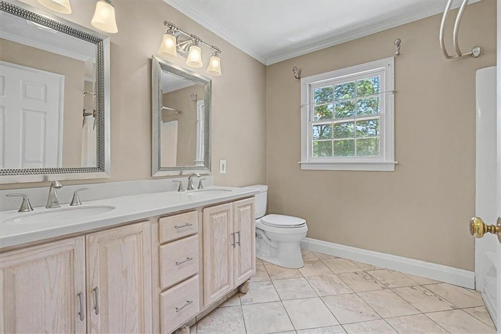 264 Bellemont Drive Southwest Rome, GA 30165 - Photo 17 of 37 a bathroom with a double vanity sink a toilet and a mirror