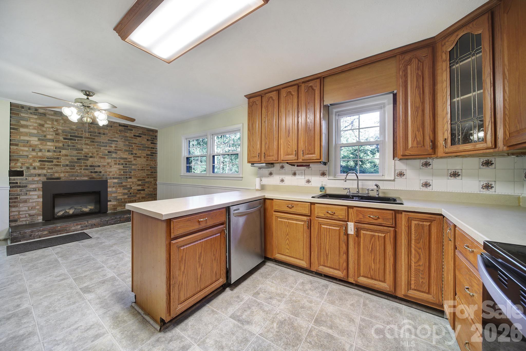 3987 Taxahaw Road Lancaster, SC 29720 - Photo 15 of 28 a kitchen with stainless steel appliances granite countertop a stove sink and cabinets