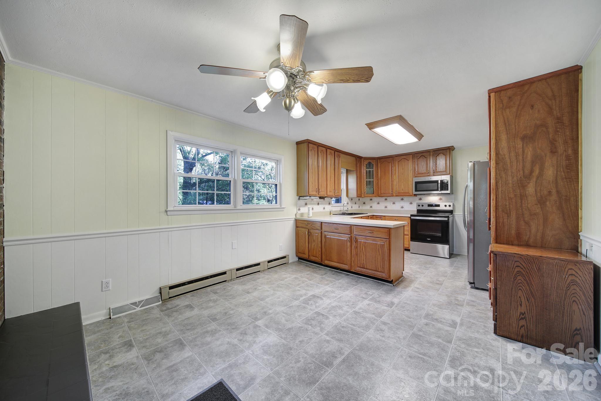 3987 Taxahaw Road Lancaster, SC 29720 - Photo 17 of 28 a kitchen with a stove a refrigerator and chandelier