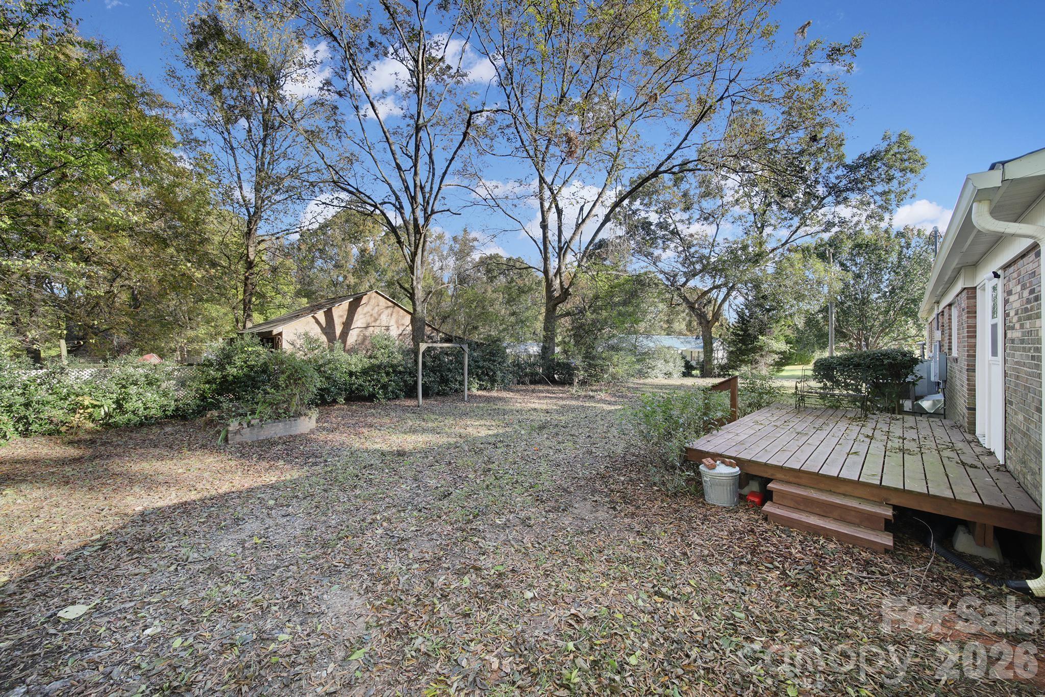 3987 Taxahaw Road Lancaster, SC 29720 - Photo 23 of 28 a view of a wooden deck with a yard and large tree