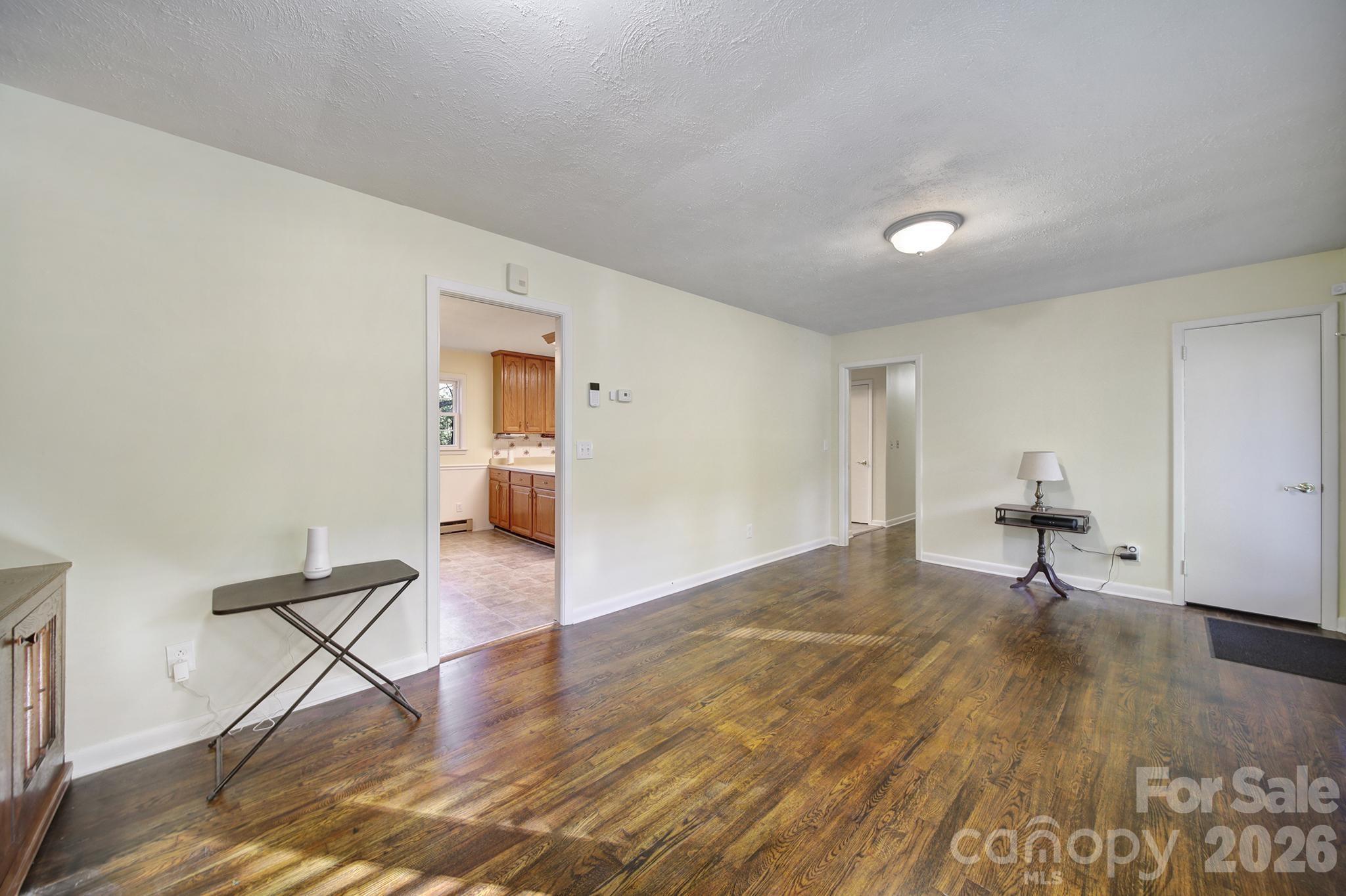 3987 Taxahaw Road Lancaster, SC 29720 - Photo 5 of 28 a view of a livingroom with wooden floor and a workspace