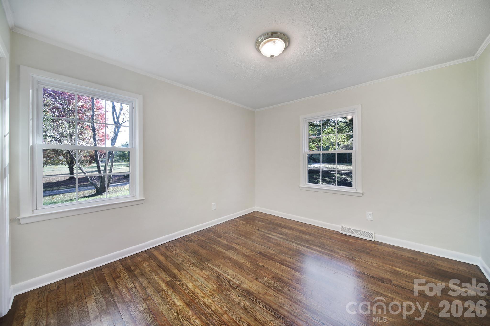 3987 Taxahaw Road Lancaster, SC 29720 - Photo 6 of 28 an empty room with wooden floor and windows