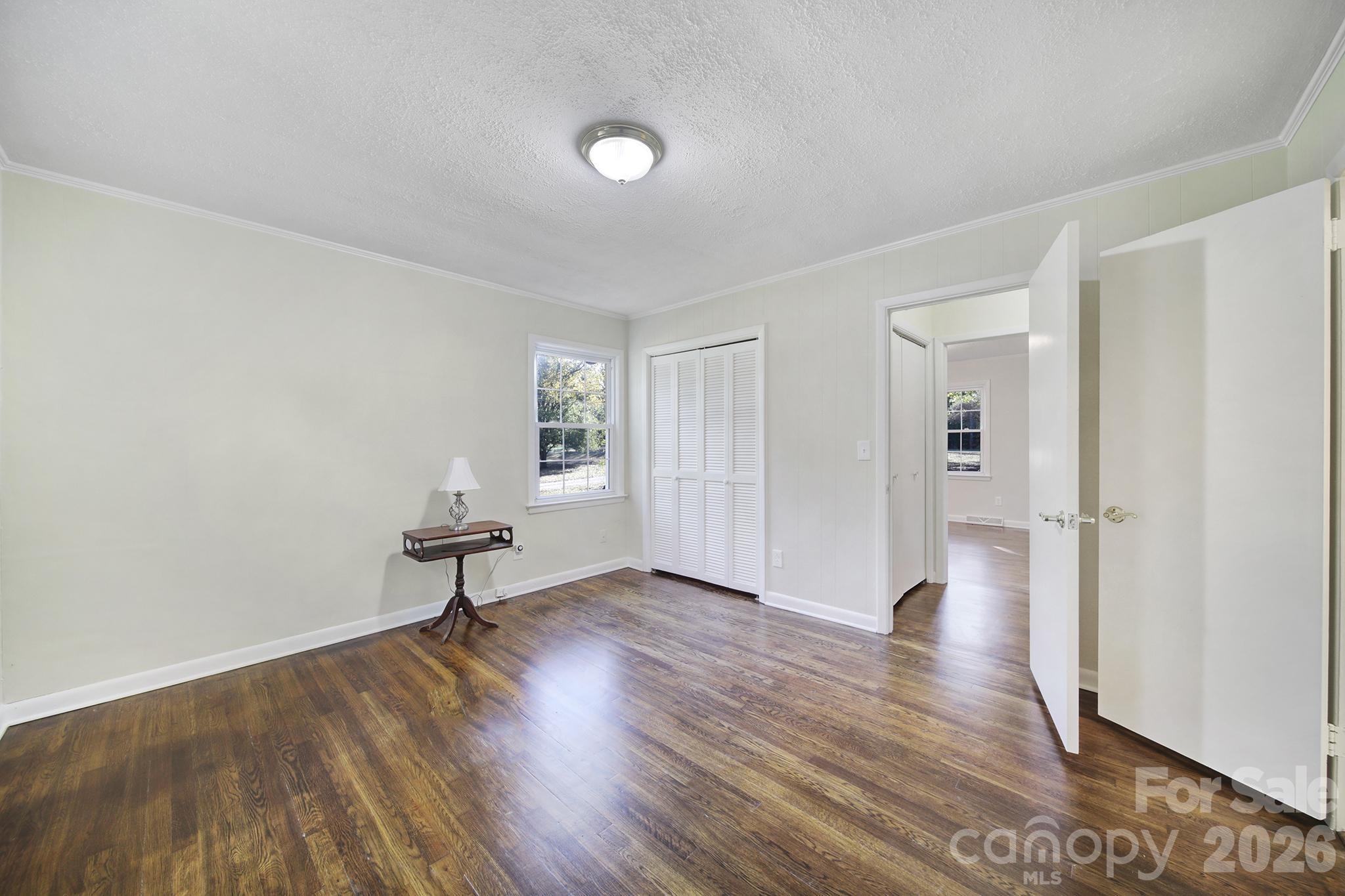 3987 Taxahaw Road Lancaster, SC 29720 - Photo 9 of 28 an empty room with wooden floor and windows