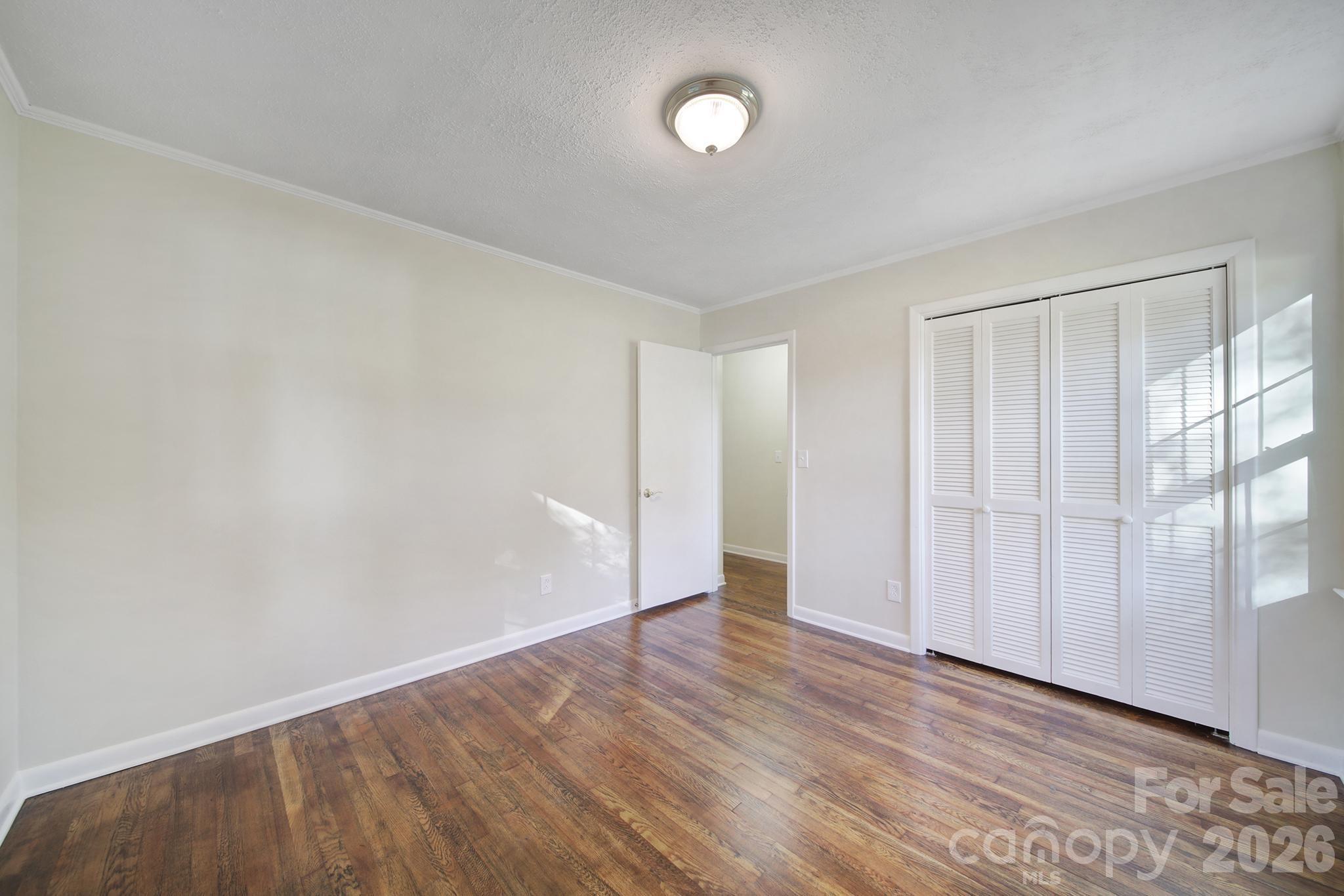 3987 Taxahaw Road Lancaster, SC 29720 - Photo 10 of 28 a view of an empty room with wooden floor and a window