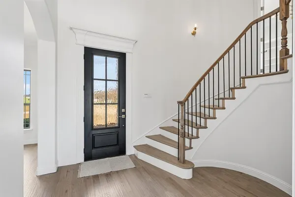 a view of entryway and hall with wooden floor