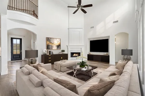 a living room with furniture a fireplace and a flat screen tv