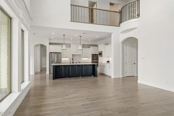 a living room with furniture and kitchen view