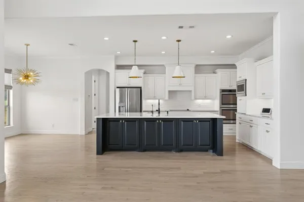 a kitchen with stainless steel appliances a refrigerator and a cabinets