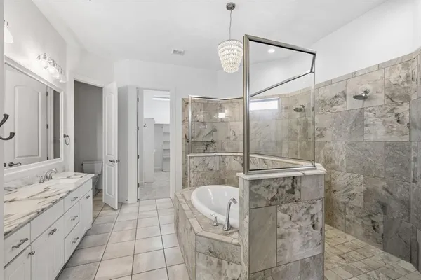 a bathroom with a shower sink and mirror