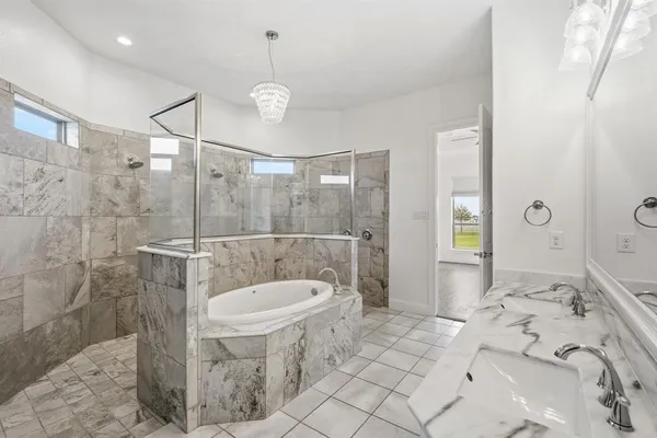 a spacious bathroom with a sink a toilet and shower
