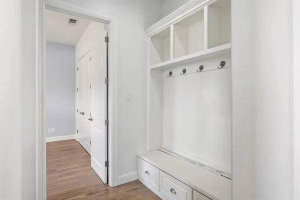a view of a hallway with wooden floor