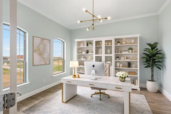 a view of a livingroom with workspace and a window
