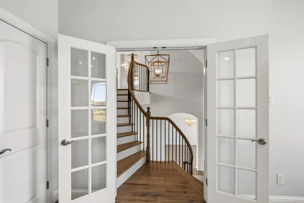 a view of entryway with wooden floor and stairs