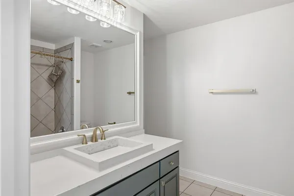 a bathroom with a sink vanity and a mirror