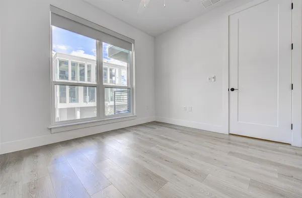 a kitchen with a sink a refrigerator and wooden floor