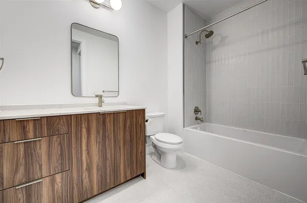 a bathroom with a toilet a sink and bathtub