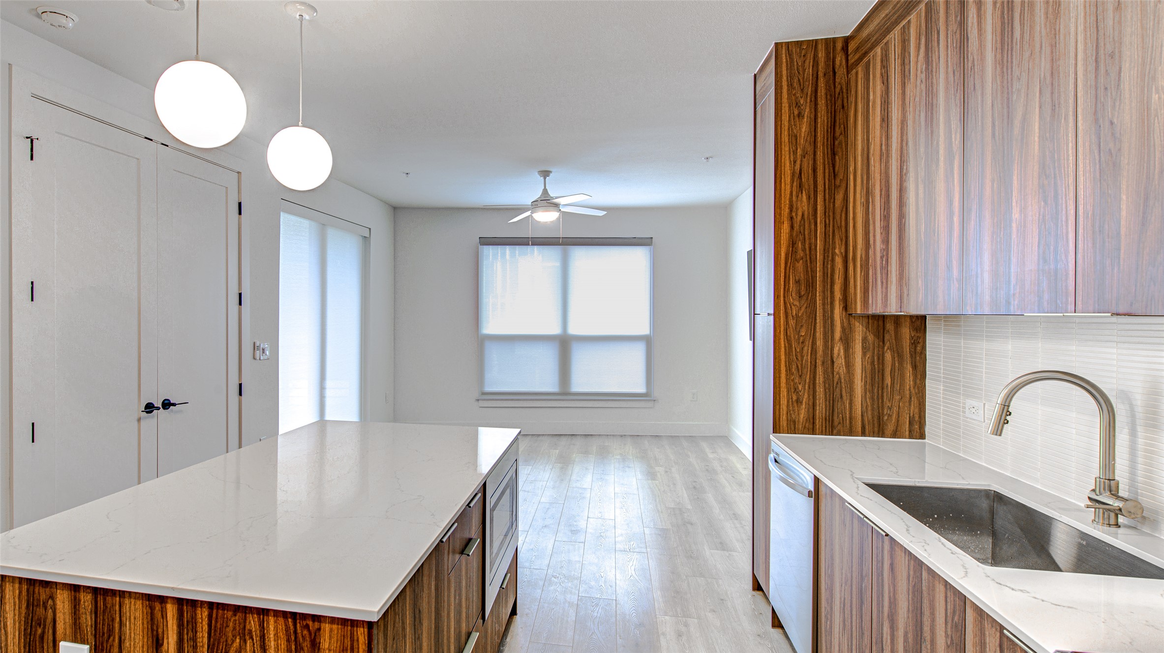 1701 Simond Avenue, Unit 229 Austin, TX 78723 - Photo 2 of 20 a kitchen with kitchen island a sink appliances cabinets and a large window