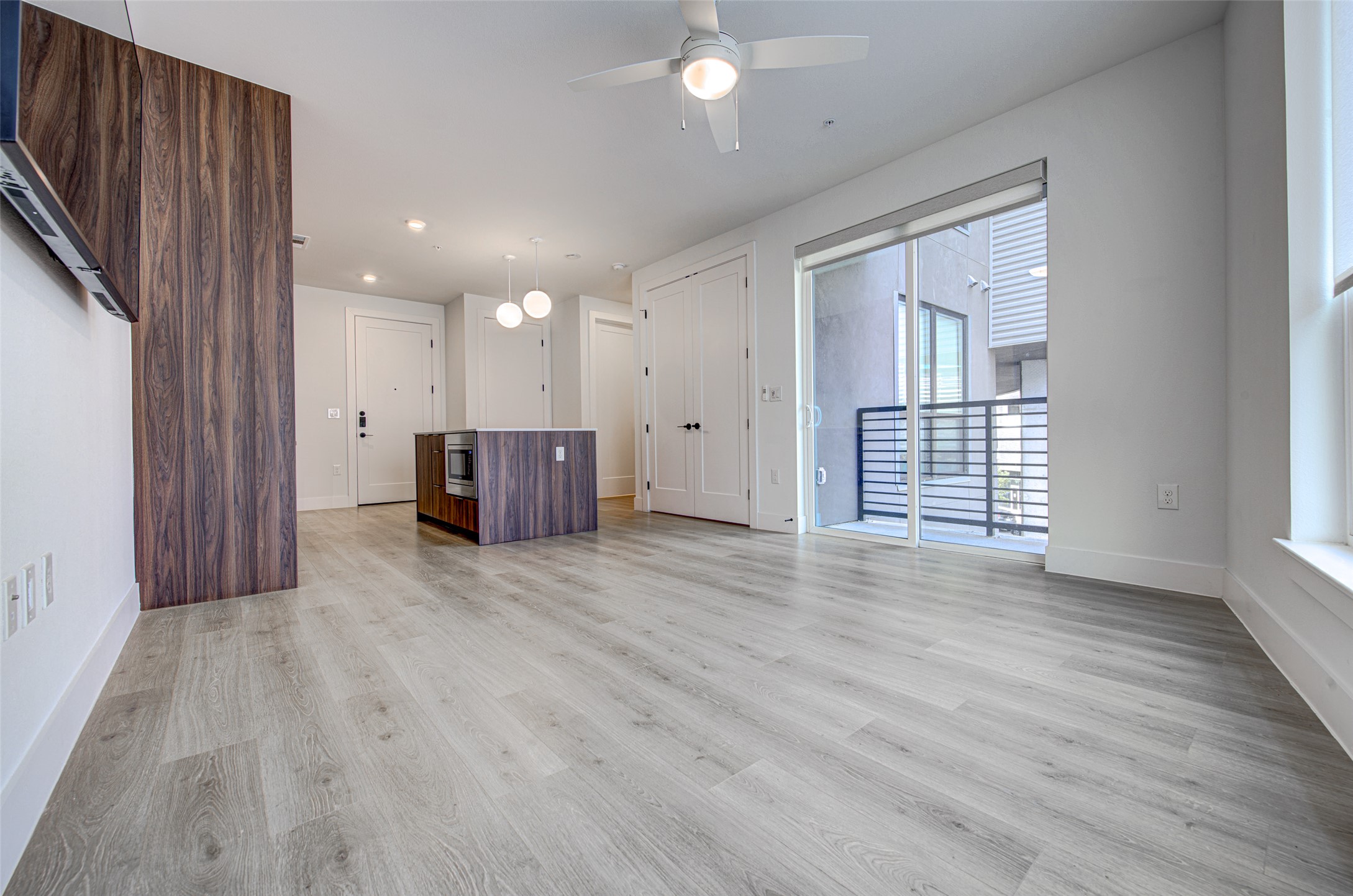 1701 Simond Avenue, Unit 229 Austin, TX 78723 - Photo 4 of 20 an empty room with wooden floor and windows