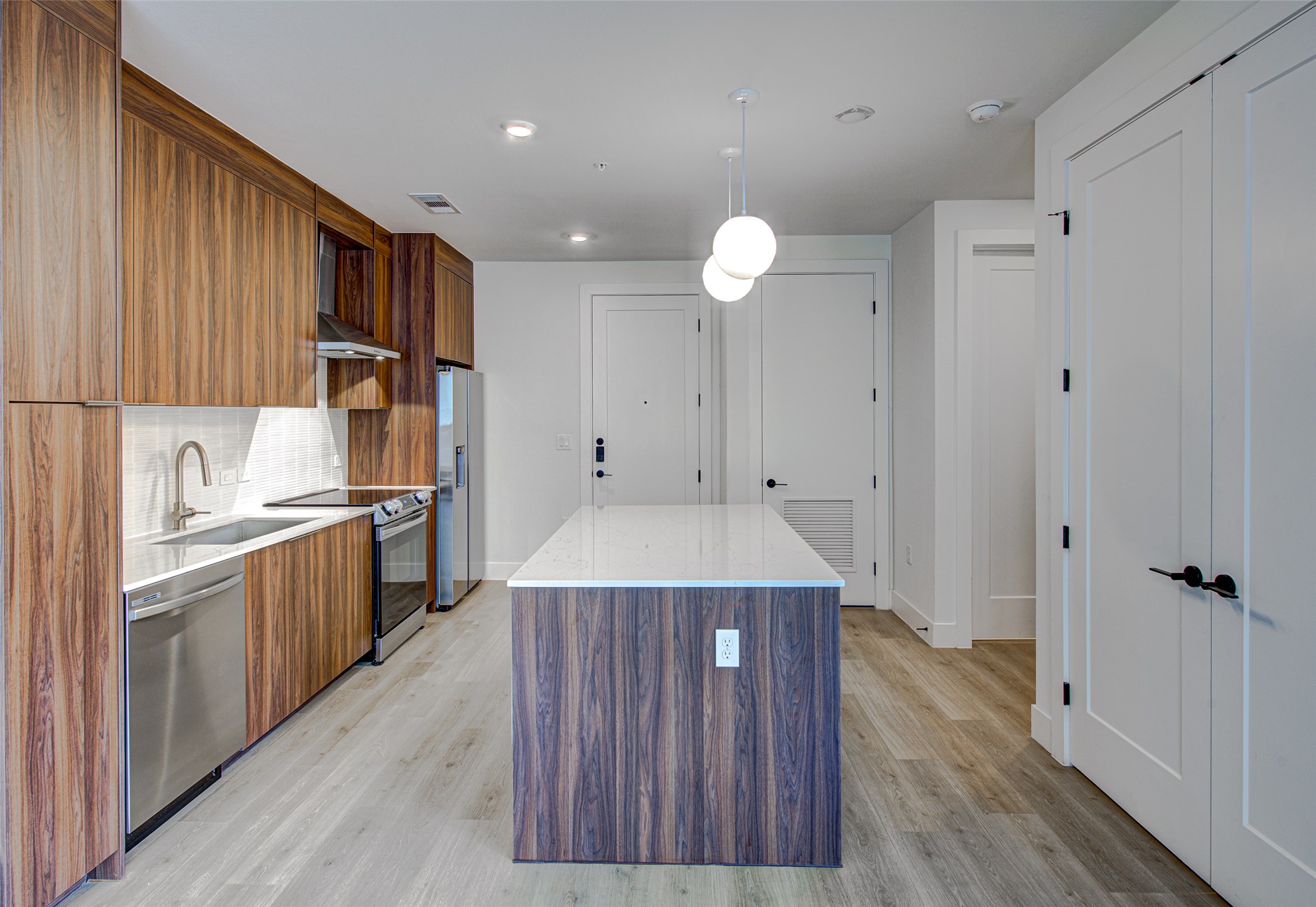 1701 Simond Avenue, Unit 229 Austin, TX 78723 - Photo 9 of 20 a kitchen with a sink a refrigerator and wooden floor