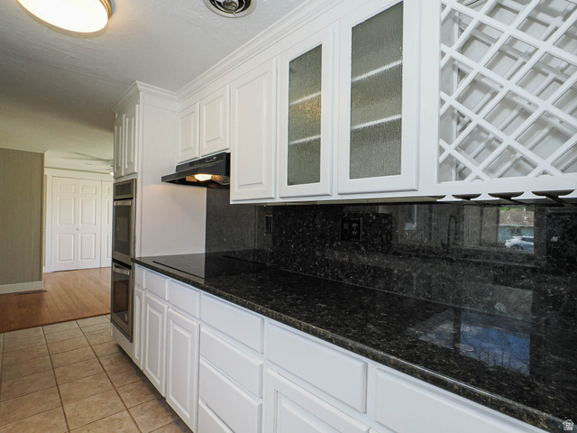 154 East 3000th Street South Bountiful, UT 84010 - Photo 4 of 37 Kitchen featuring white cabinetry, dark speckled countertops, tile flooring, built-in double ovens, and a wine rack