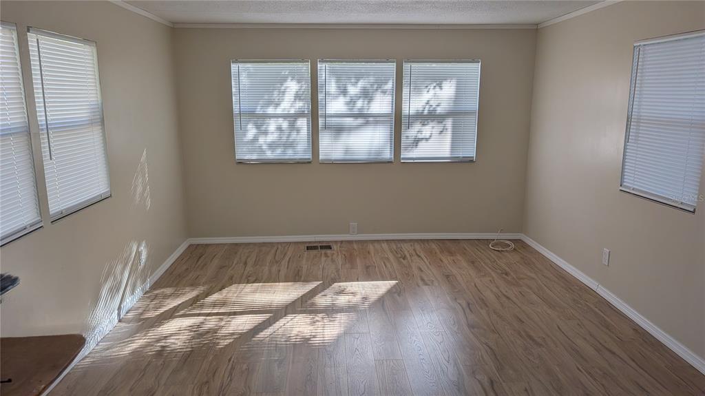 11730 East U Highway Seffner, FL 33584 - Photo 5 of 11 a view of a room with wooden floor and window