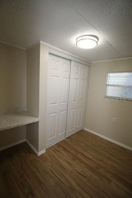11730 East U Highway Seffner, FL 33584 - Photo 6 of 11 an empty room with wooden floor and windows
