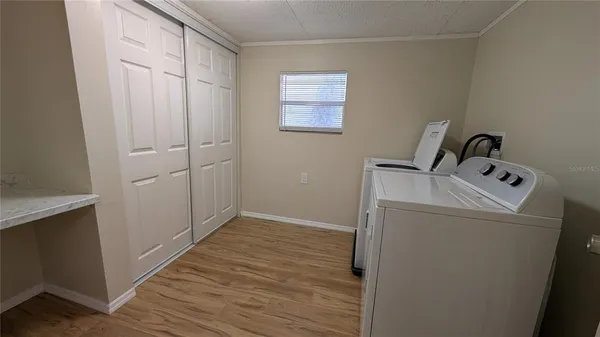 a view of a storage & utility room with wooden floor
