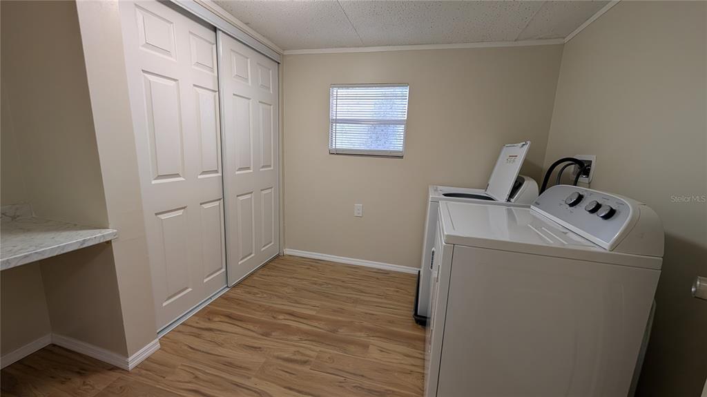 11730 East U Highway Seffner, FL 33584 - Photo 7 of 11 a view of a storage & utility room with wooden floor