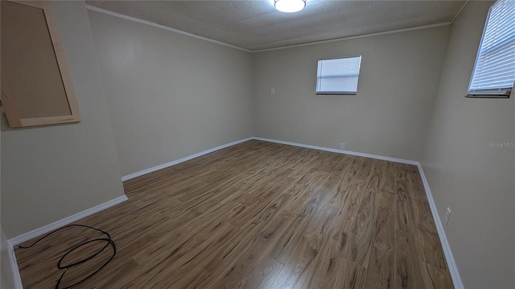 11730 East U Highway Seffner, FL 33584 - Photo 8 of 11 a view of a room with wooden floor and a window