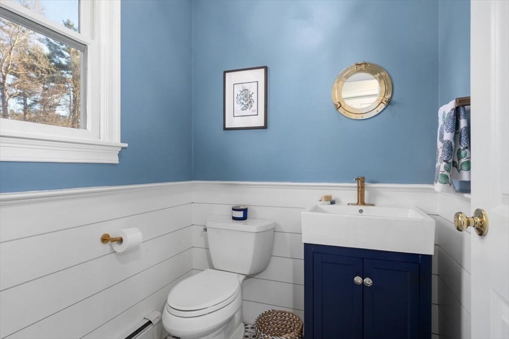 125 Maple Street Scituate, MA 02066 - Photo 17 of 42 a bathroom with a toilet a sink and mirror