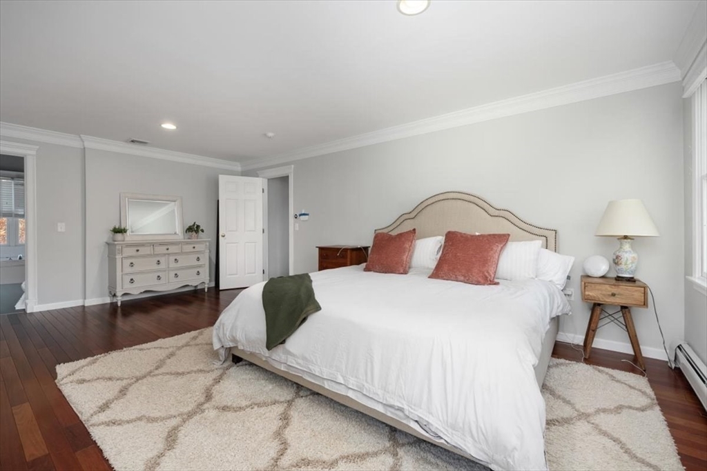 125 Maple Street Scituate, MA 02066 - Photo 19 of 42 a bedroom with a bed and a lamp