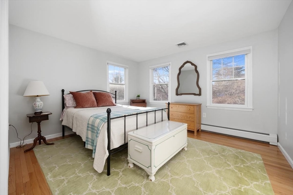 125 Maple Street Scituate, MA 02066 - Photo 23 of 42 a bedroom with a bed and a large window